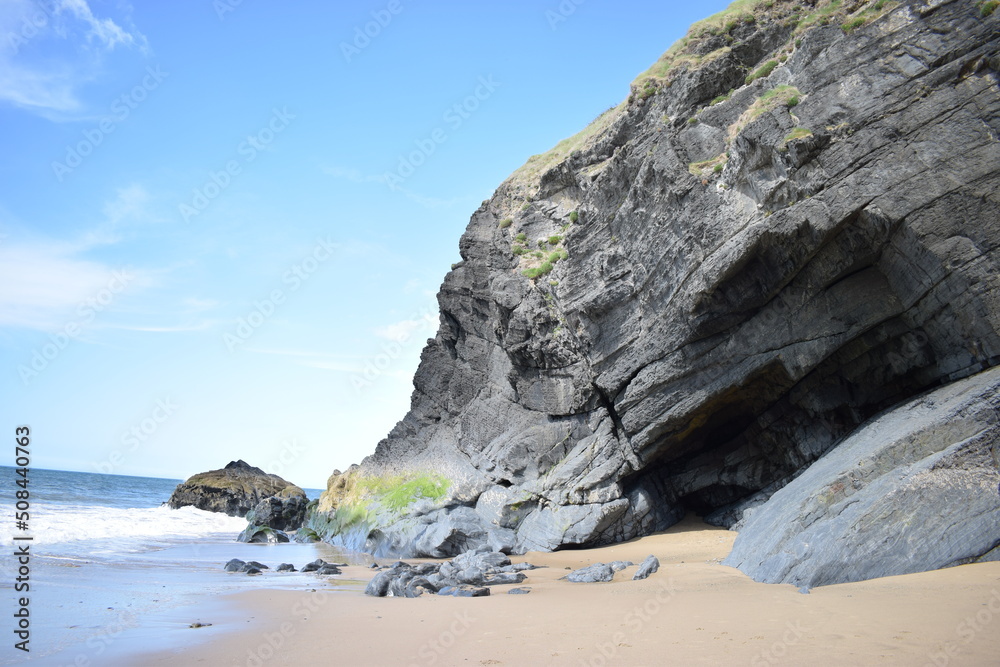 Cave in the cliff near Penbryn Beach, Wales, UK. Cave in the cliff near Penbryn Beach, Wales, UK.