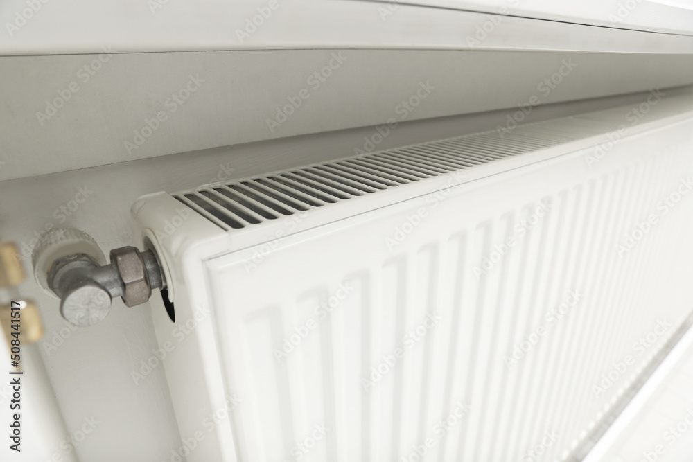 Closeup view of modern radiator. Central heating system Closeup view of modern radiator. Central heating system