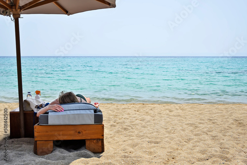 young woman sunbathing on luxurious sunbed © conzorb