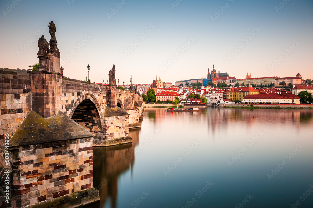 Charles Bridge over the Vltava river and view of Old Town at sunrise in Prague, Czech Republic. Famous travel destination. Summer cityscape