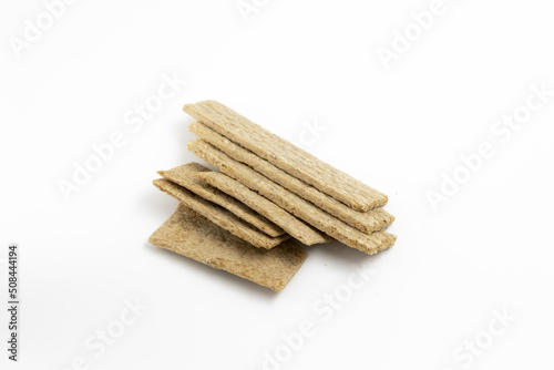 A few dry wheat diet light thin loaves on a white background isolated top view
