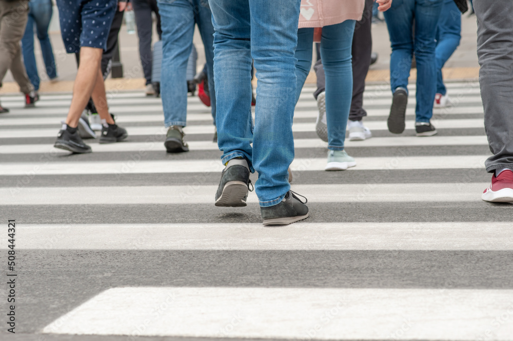People crossing street in city, closeup view People crossing street in city, closeup view