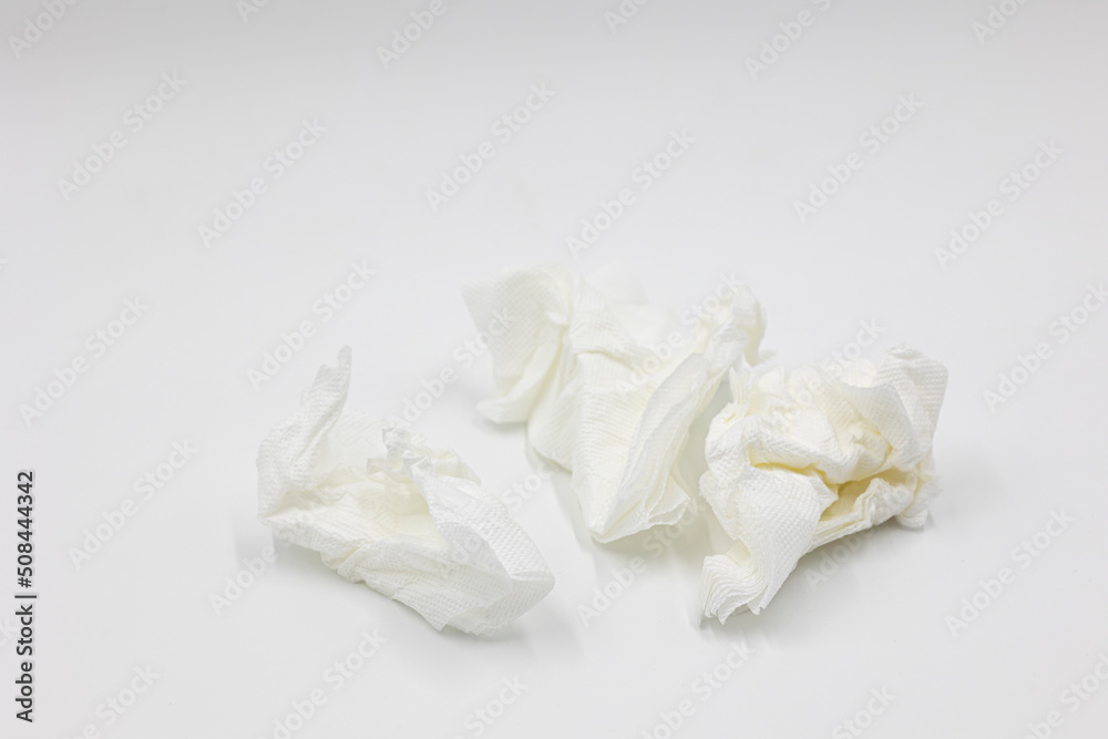 Several crumpled white used white paper napkins isolated on a white background Several crumpled white used white paper napkins isolated on a white background