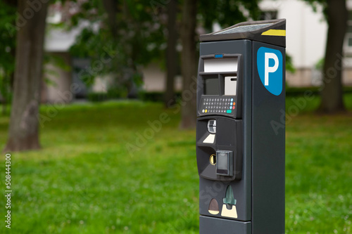 Modern parking meter outdoors. Space for text
