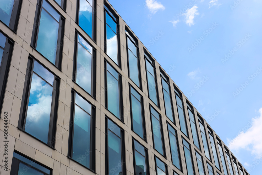 Modern building against blue sky, low angle view Modern building against blue sky, low angle view