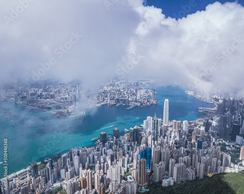 Epic aerial view of the Victoria Harbour in a clear day, with thick cloud and sunlight © gormakuma