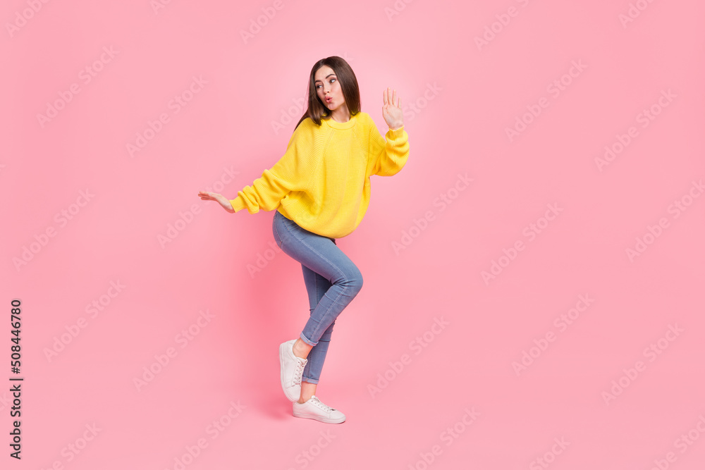 Full size photo of young adorable girl good mood chill free-time look empty space isolated over pink color background