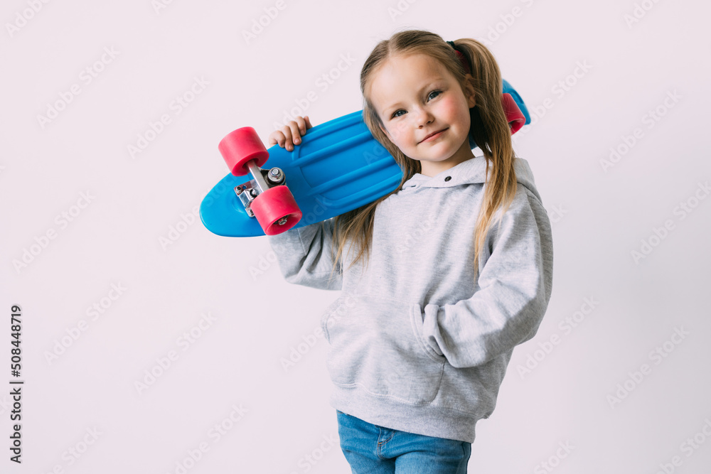 Little girl child with skateboard over white background Little girl child with skateboard over white background