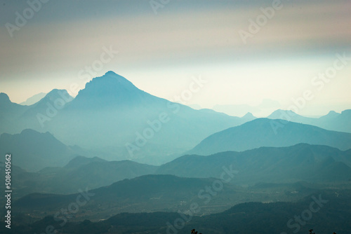 The beautiful blues of the view from Cabeçó d'Or en Alicante of the larger mountain Aitana and surrounding mountains. photo