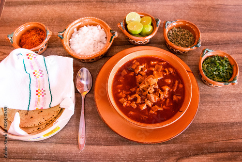 Plato de menudo con condimentos  photo