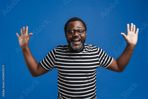 Adult african american man smiling and raising hands
