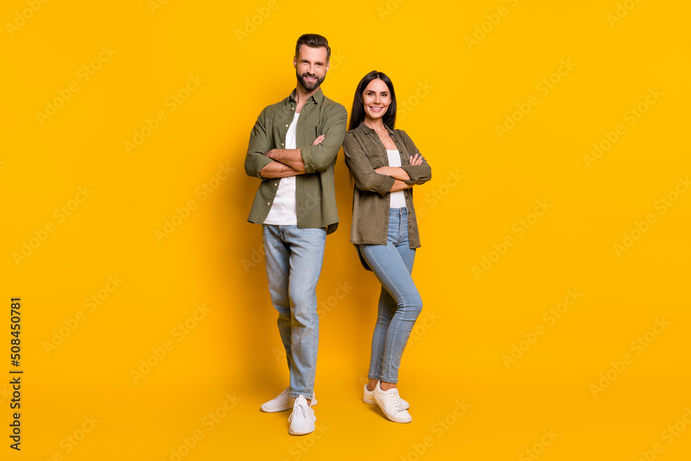 Full body photo of young confident man woman folded hands team colleagues isolated over yellow color background