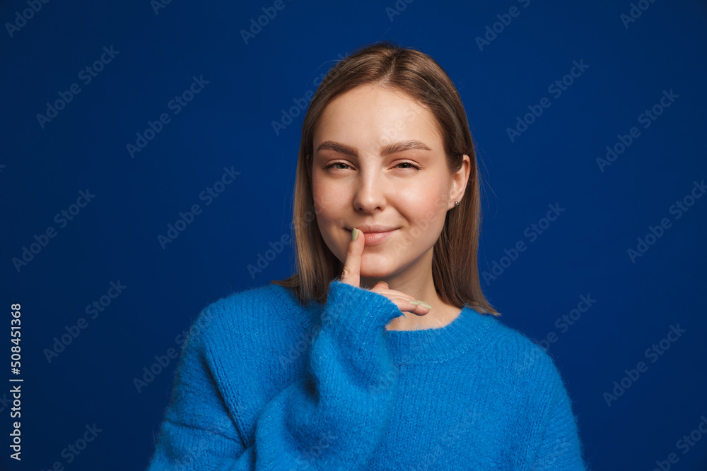 Fototapeta premium Young white happy woman wearing sweater looking at camera