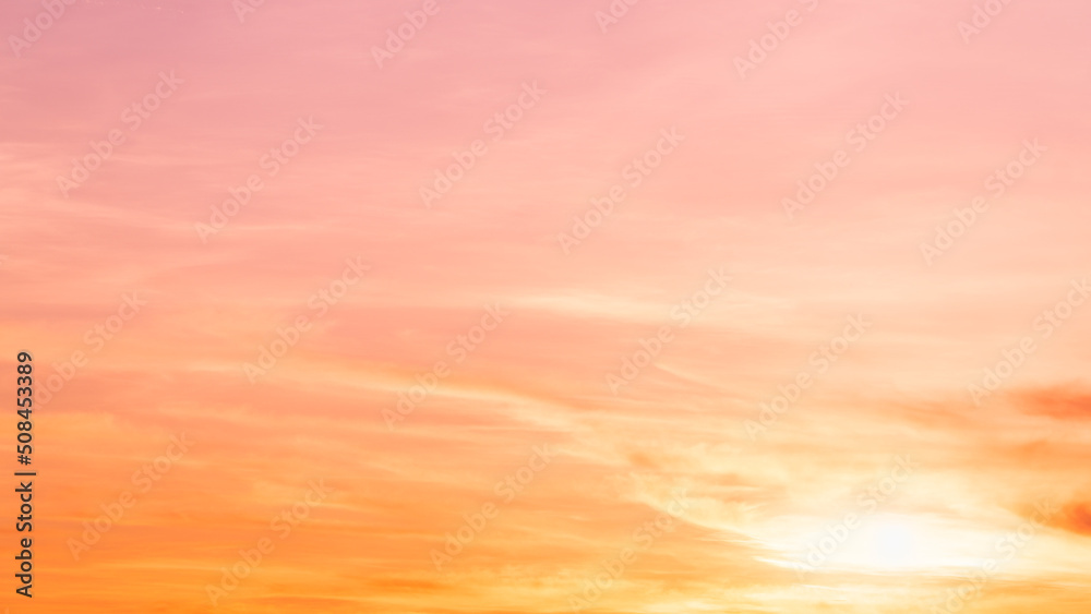Evening sky with romantic colorful sunlight with bright orange, yellow and pink sunset dramatic nature pastel background.