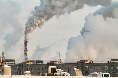 industrial chimneys with heavy white smoke causing air pollution problem 