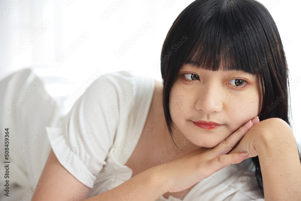 Beautiful young Asian woman sleeping on bed relaxing in the morning light with white room Beautiful young Asian woman sleeping on bed relaxing in the morning light with white room