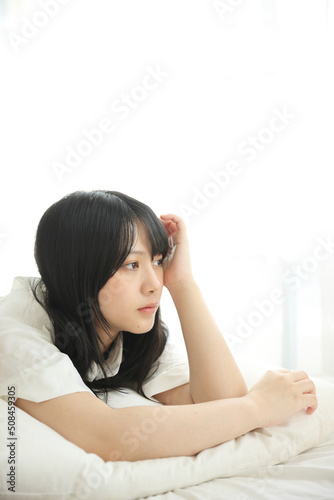 Beautiful young woman waking up in the morning at white bedroom © Oran Tantapakul