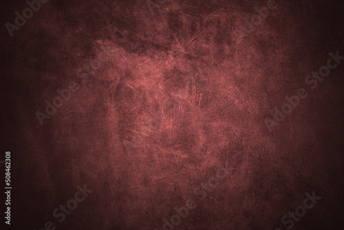 Beautiful red background with genuine leather texture with pattern of red leather with dark red leather around edges of background and light red leather in center of background image
