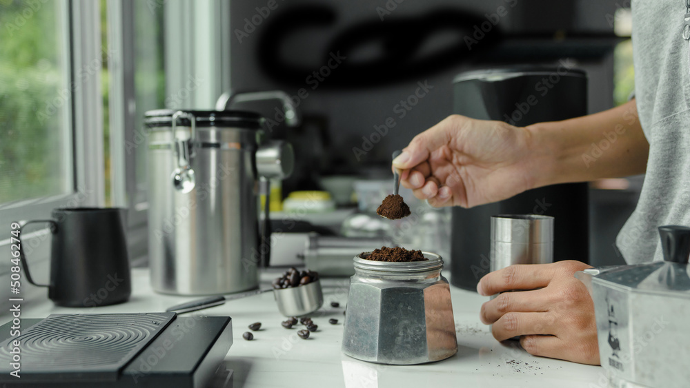 powder coffee on a stainless spoon with hand people pour Roasted coffee for espresso coffee into the cup with equipment tool brewing Italian Moka pot, preparation coffee powder coffee on a stainless spoon with hand people pour Roasted coffee for espresso coffee into the cup with equipment tool brewing Italian Moka pot, preparation coffee