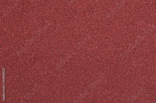 maroon sponge foam material surface texture background. absorbent, porous material with fine grains