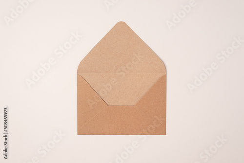 Open craft envelope on a light background of a milky color