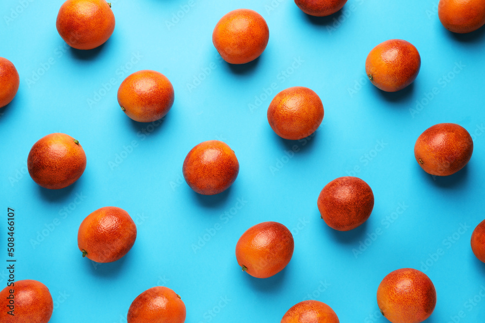 Many ripe sicilian oranges on light blue background, flat lay Many ripe sicilian oranges on light blue background, flat lay