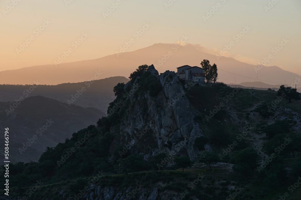 the Etna volcano in the background from the Nebrodi mountains at the first light of dawn