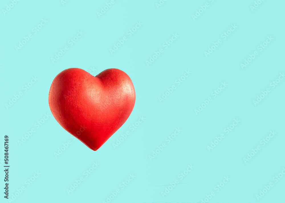 Big red heart against bright blue background. Minimal creative love concept. 