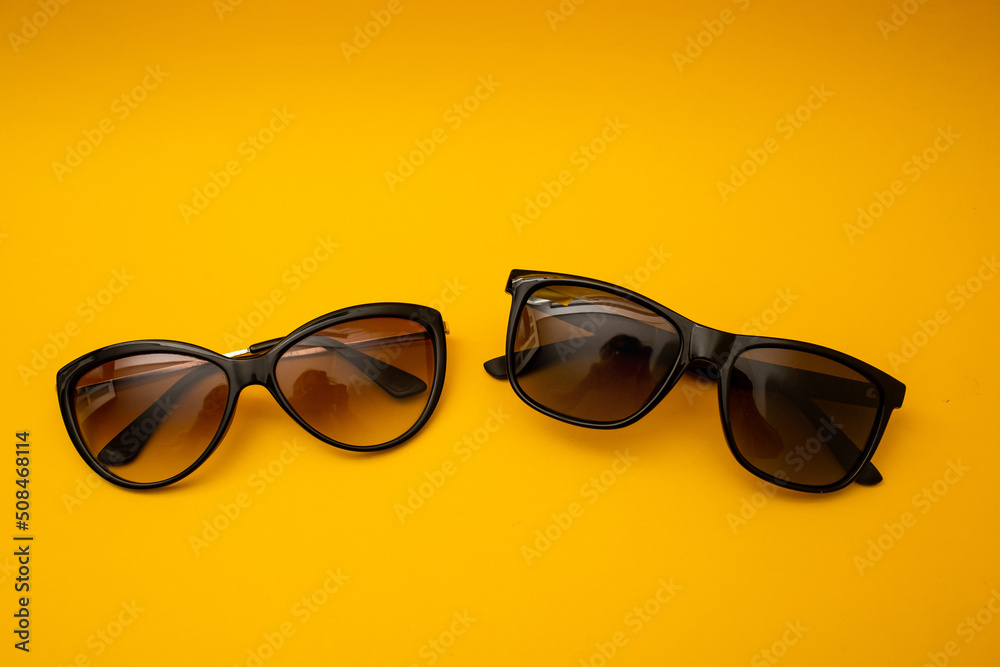 Black s sunglasses on orange background Black s sunglasses on orange background