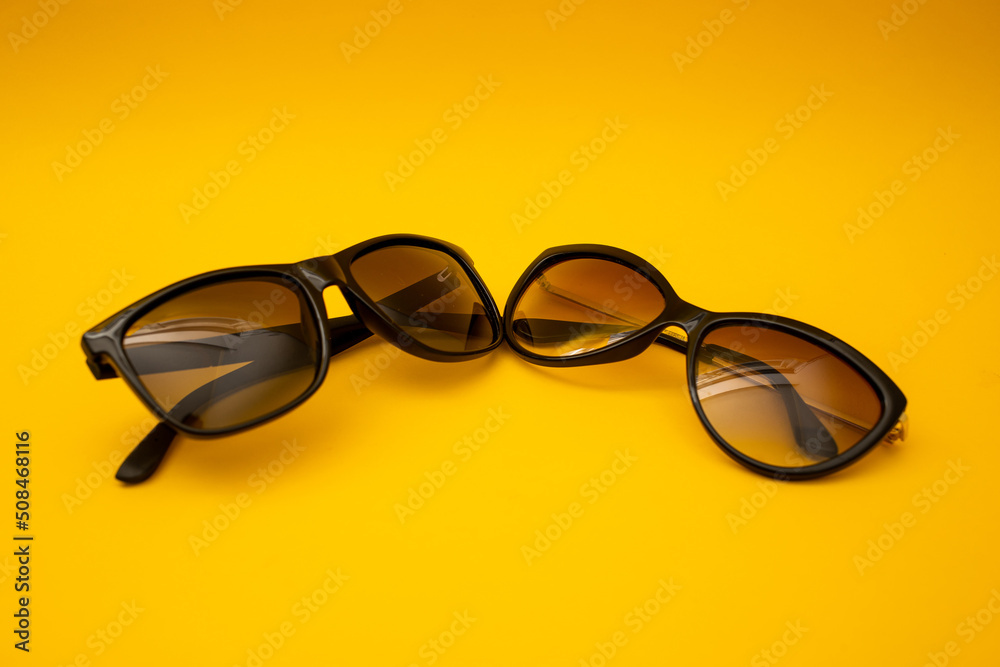 Black s sunglasses on orange background