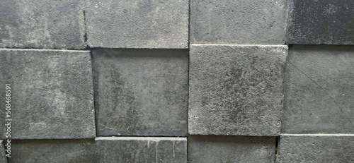 3D square textured stone black wall.