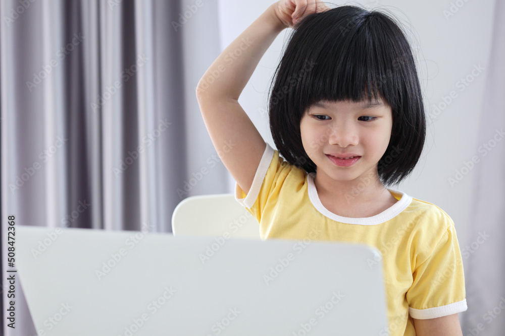 little asian girl student study online using laptop computer at home little asian girl student study online using laptop computer at home