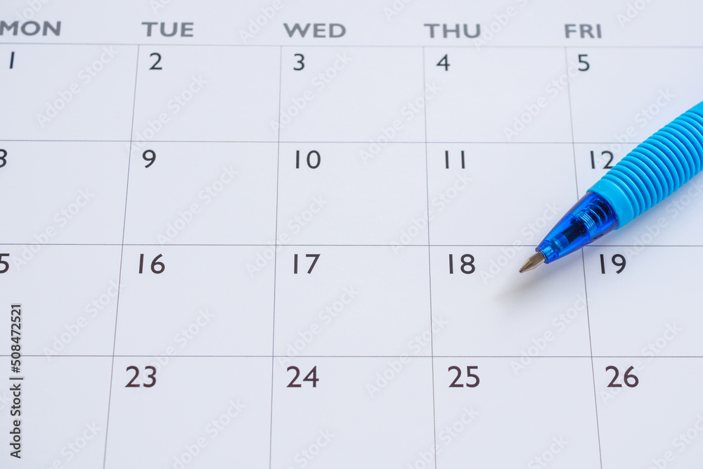 Blue pen on calendar page background business planning appointment meeting concept Blue pen on calendar page background business planning appointment meeting concept