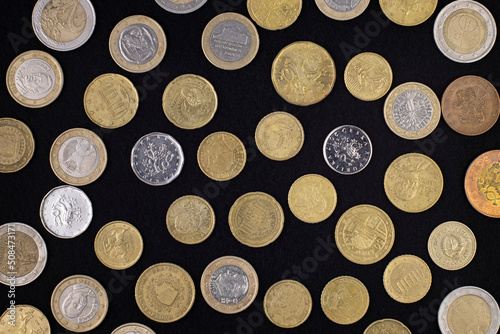 Pattern of European coins on a black cloth  top view  close-up.