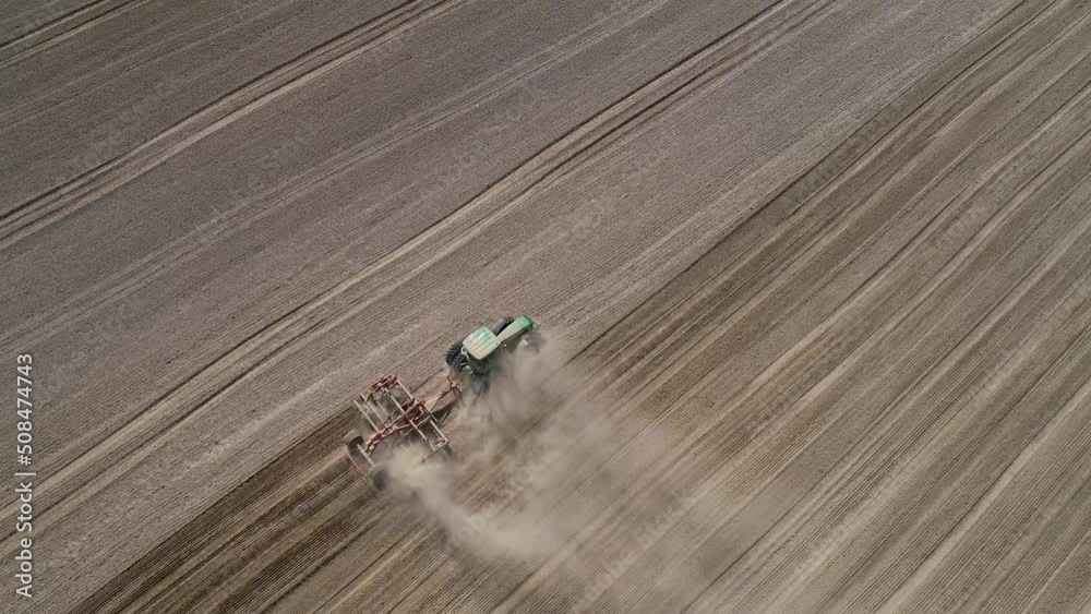 Agricultural green big tractor in the field plowing. 4k video Agricultural green big tractor in the field plowing. 4k video