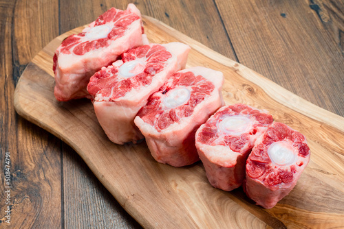 Portions of fresh ox tail on a wooden cutting board. Meat industry product. Top quality beef.