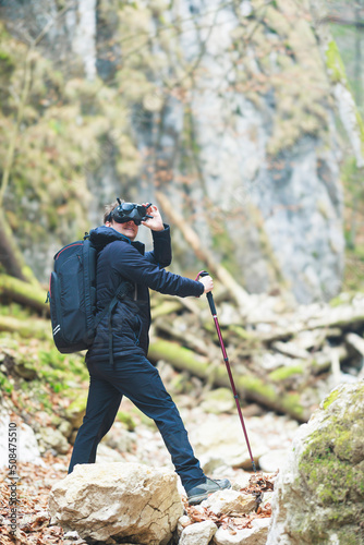 Hiking in the mountains with VR glasses. Virtual reality technology is a virtual mountain trip that enables you to travel with your friends, family, and co-workers to remote parts of the world