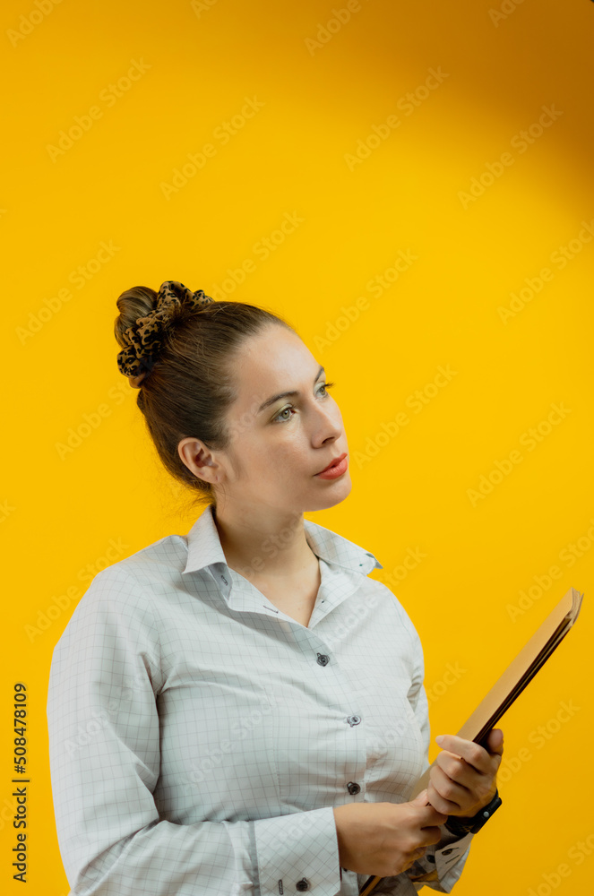 enterprising woman making important decisions , working in sales on her tablet , with her folders and files enterprising woman making important decisions , working in sales on her tablet , with her folders and files