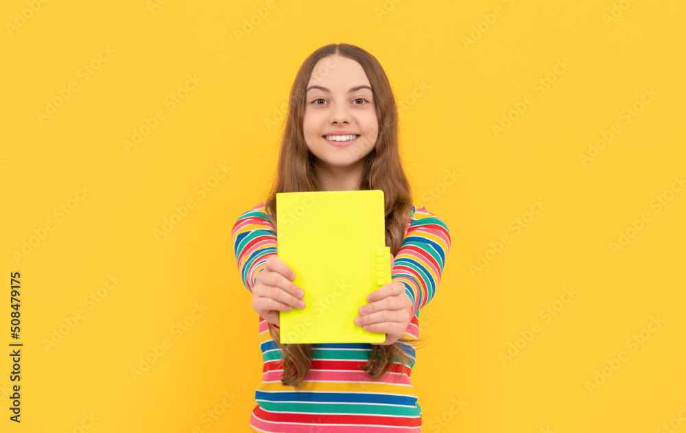 Happy kid smile showing school book for copy space yellow background, knowledge Happy kid smile showing school book for copy space yellow background, knowledge
