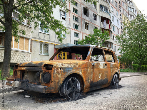 Consequences of the war in Ukraine, destroyed houses and burned cars. Cars of civilians were shot and burned. War of Russia against Ukraine. Cars damaged after shelling. Kharkov, Ukraine. War crimes