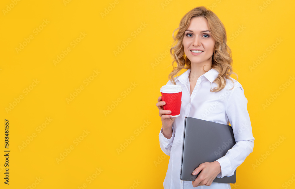 positive blonde woman with coffee cup and laptop on yellow background positive blonde woman with coffee cup and laptop on yellow background
