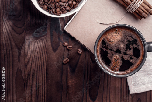 Cup of coffee. Concept of breakfast. Cynamon in a bunch. Grains of coffee