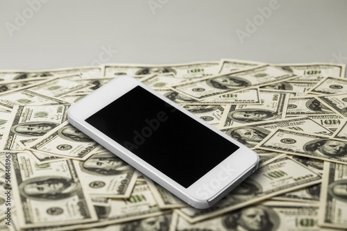 Smartphone with screen on dollars. photo