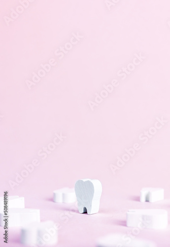 Banner with white perfect teeth on pink background. Dental care, stomatology, dentist work, plaque, cavity and gum disease prevention concept. Place for text. High quality photo