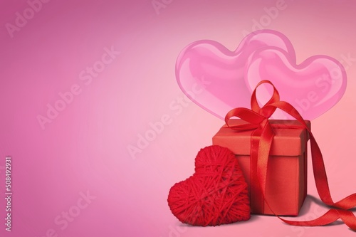 Gift Box and Heart Shape on Pink Background. Love, birthday or Valentine's Day concept.