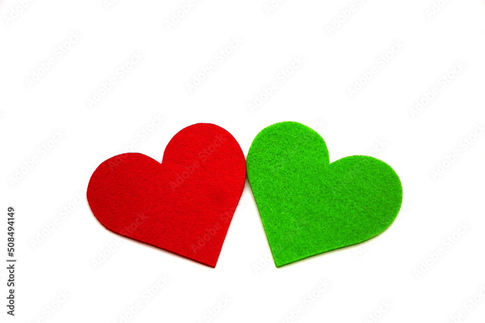 Red and green colored heart shapes made of felt with decorative pins, shot on white. Red and green colored heart shapes made of felt with decorative pins, shot on white.