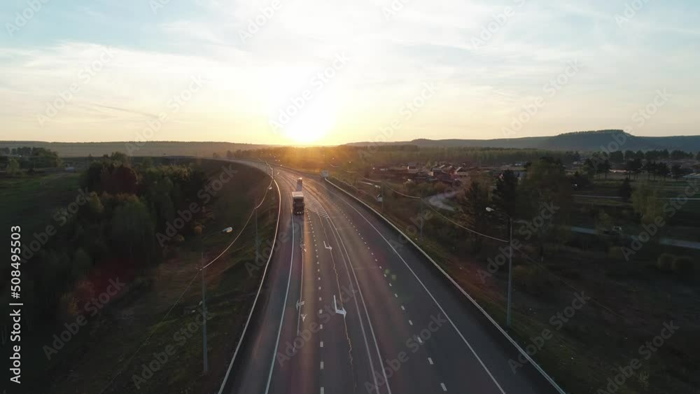 Aerial view of an intercity highway with traffict in rural area in the morning. Beautiful sunrise Aerial view of an intercity highway with traffict in rural area in the morning. Beautiful sunrise