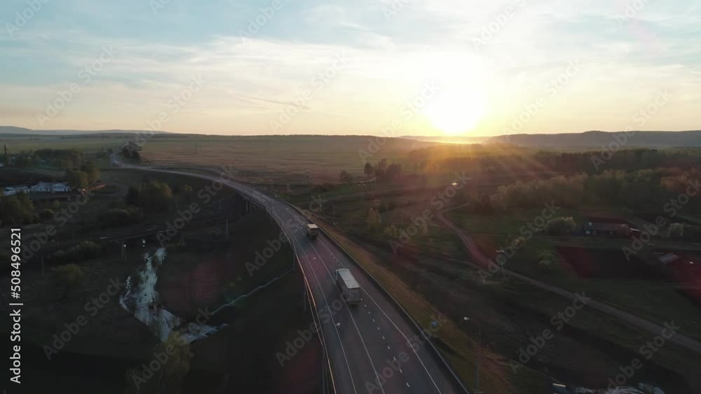Aerial view of an intercity highway with traffict in rural area in the morning. Beautiful sunrise Aerial view of an intercity highway with traffict in rural area in the morning. Beautiful sunrise
