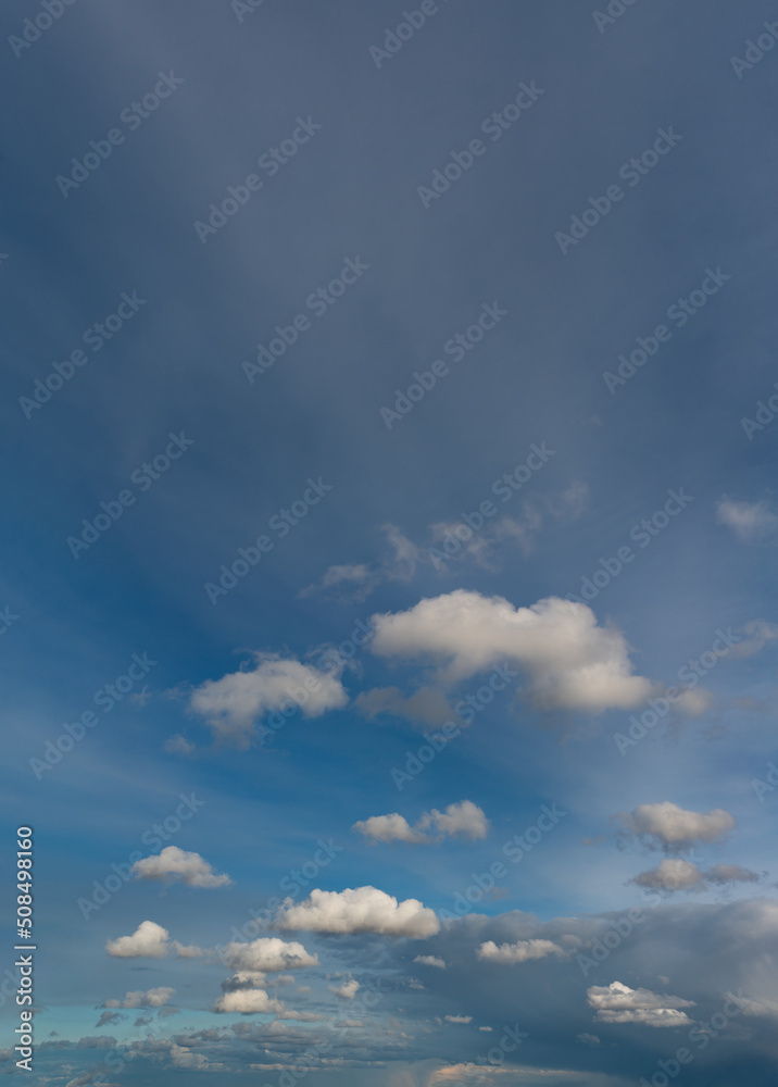 Fototapeta premium Fantastic clouds at sunrise, vertical panorama