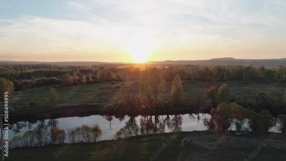 Aerial view of a river surrounded with green trees at foggy sunrise. Calm morning and relaxing atmosphere. Beautiful landscape Aerial view of a river surrounded with green trees at foggy sunrise. Calm morning and relaxing atmosphere. Beautiful landscape